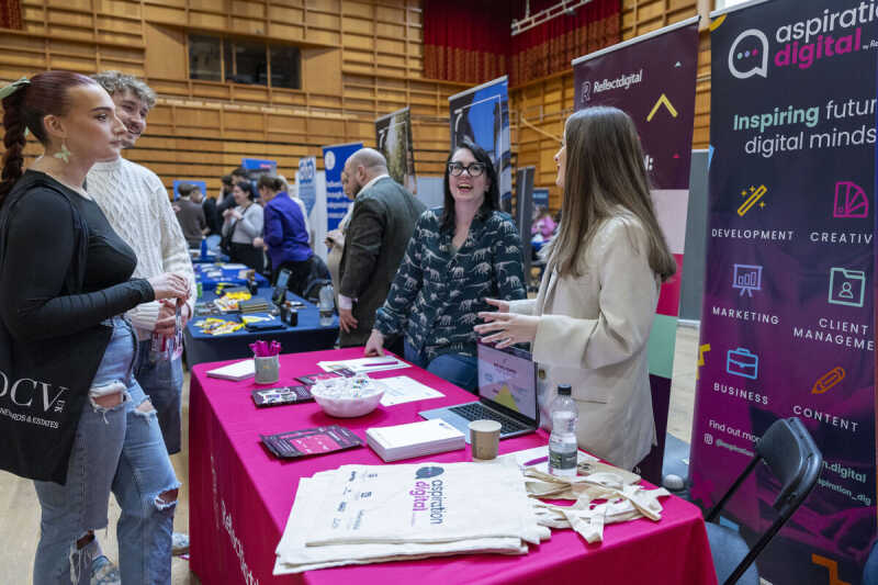 Employers and University of Kent student chatting at the careers fair.
